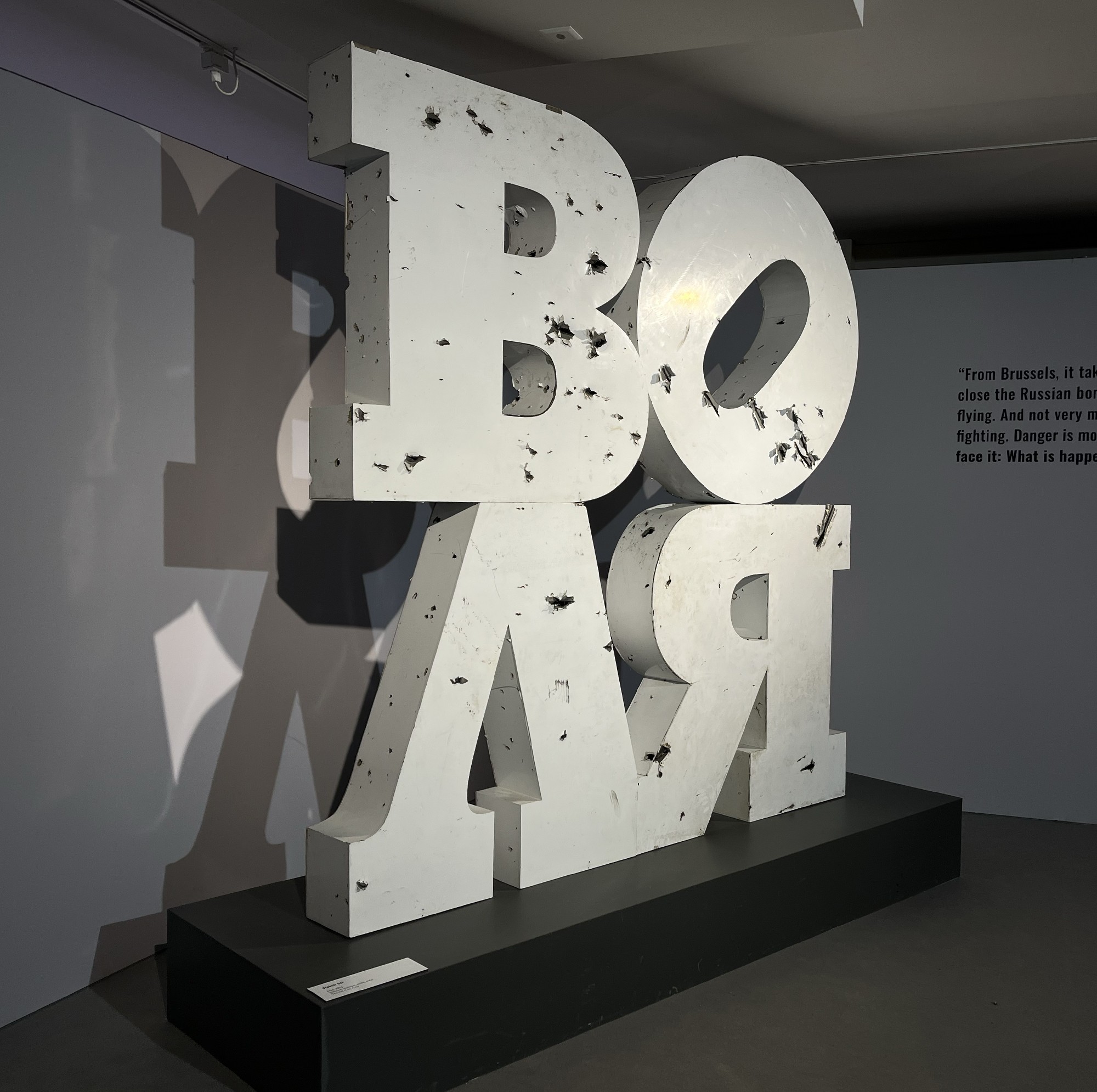 Volia . 2025, sculpture.  Plastic letters, metal, composite panels. 3 x 3.5 x 1m